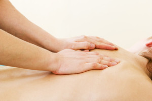 A female receives a shoulder massage at a day spa.